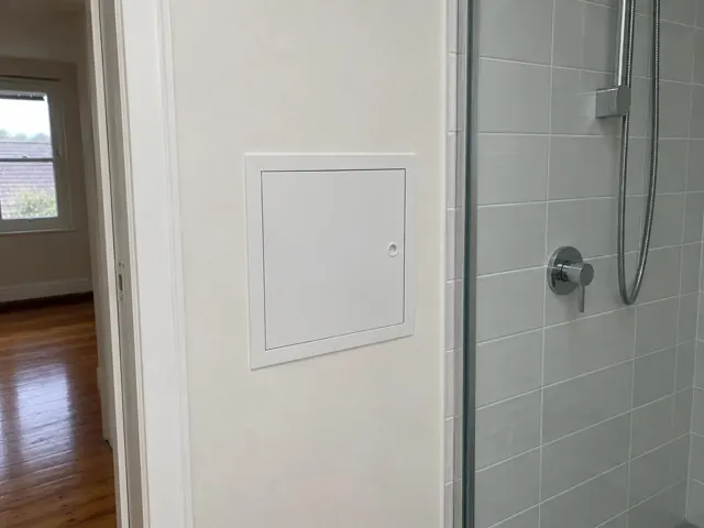 Neat access panel in a bathroom wall beside a tiled shower in Maroubra